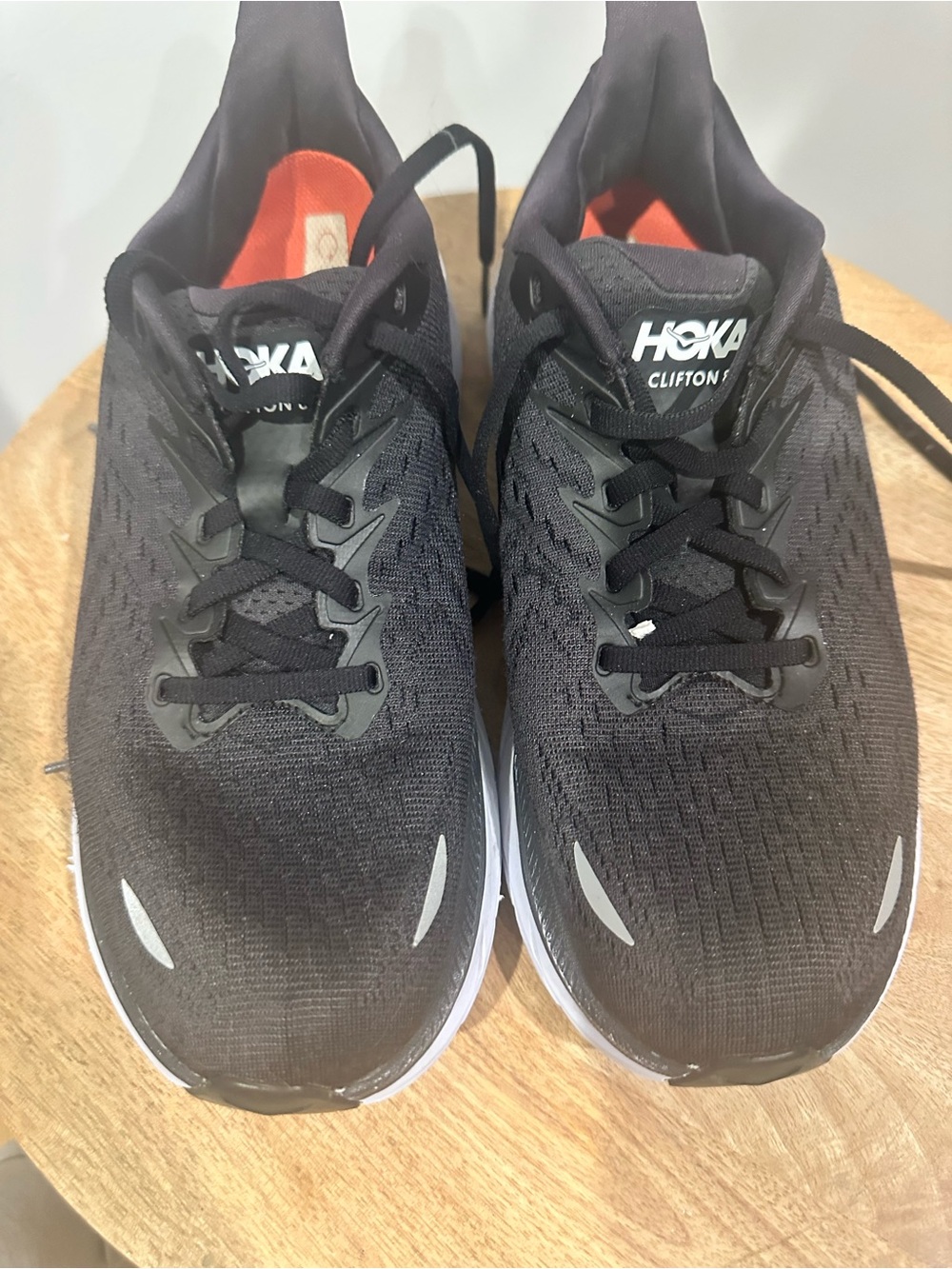 Hoka Clifton Running Sneakers in Black with White Soles and Orange Linings